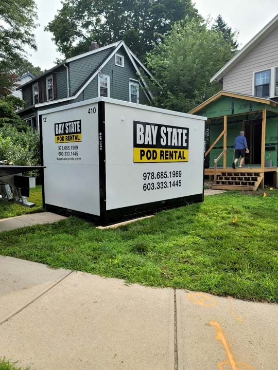 Bay State 12-foot storage pod in front of house